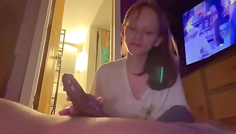 Brunette milf with a huge cock sucking it on the couch